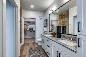 Spacious walk-in closets with custom wood shelving